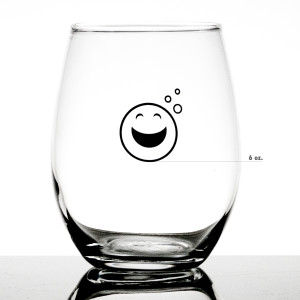Stemless Measuring Wine Glass with large happy emoji showing measurement of 6 ounces