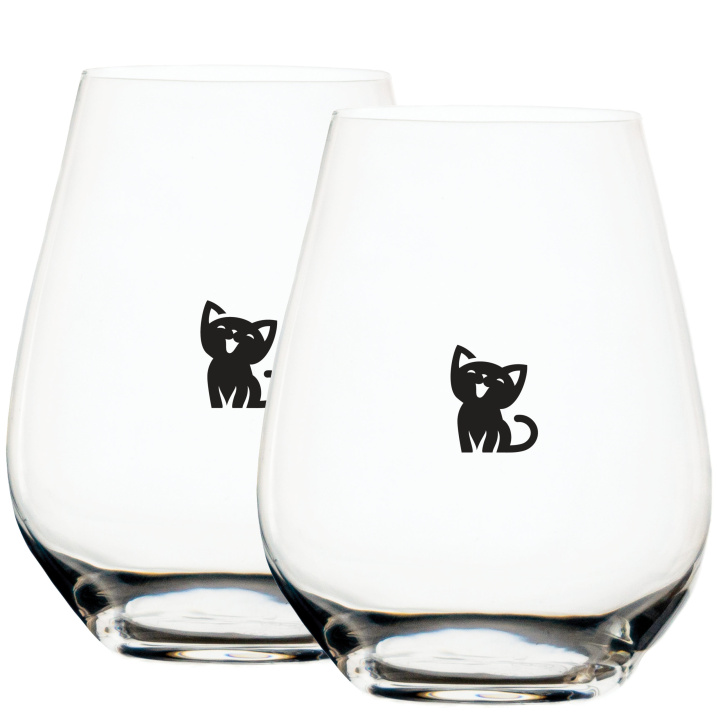 adorable black happy kitten displayed on two measuring wine glasses
